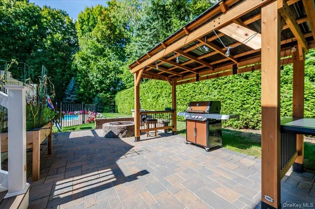 a view of a house with backyard and sitting area