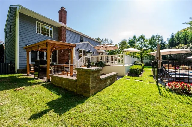 a view of yard with green and white house