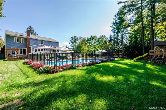 an aerial view of a house with a garden and swimming pool