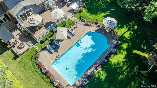 an aerial view of a house with a yard and lake view