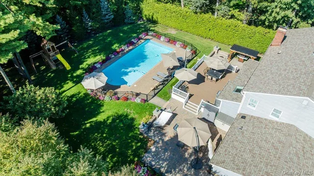 an aerial view of a house with a yard and garden
