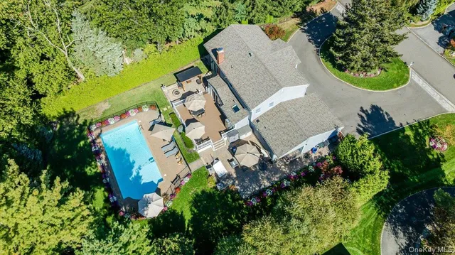 an aerial view of a house with a yard and basket ball court