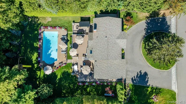 an aerial view of a house with a yard and garden