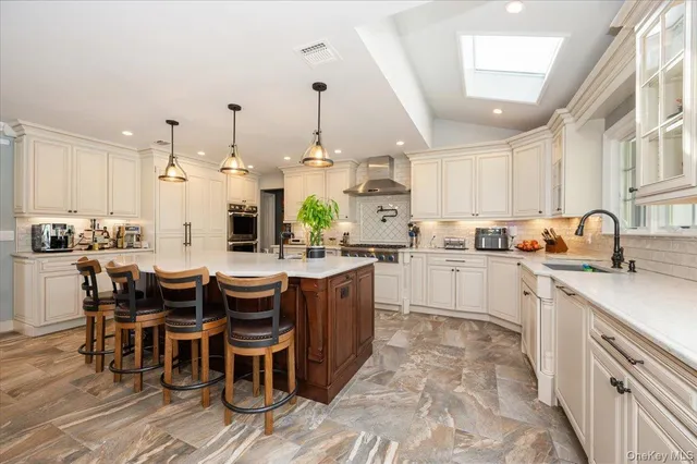 a kitchen with a sink and chairs