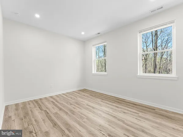 a view of a small space with wooden floor and a window