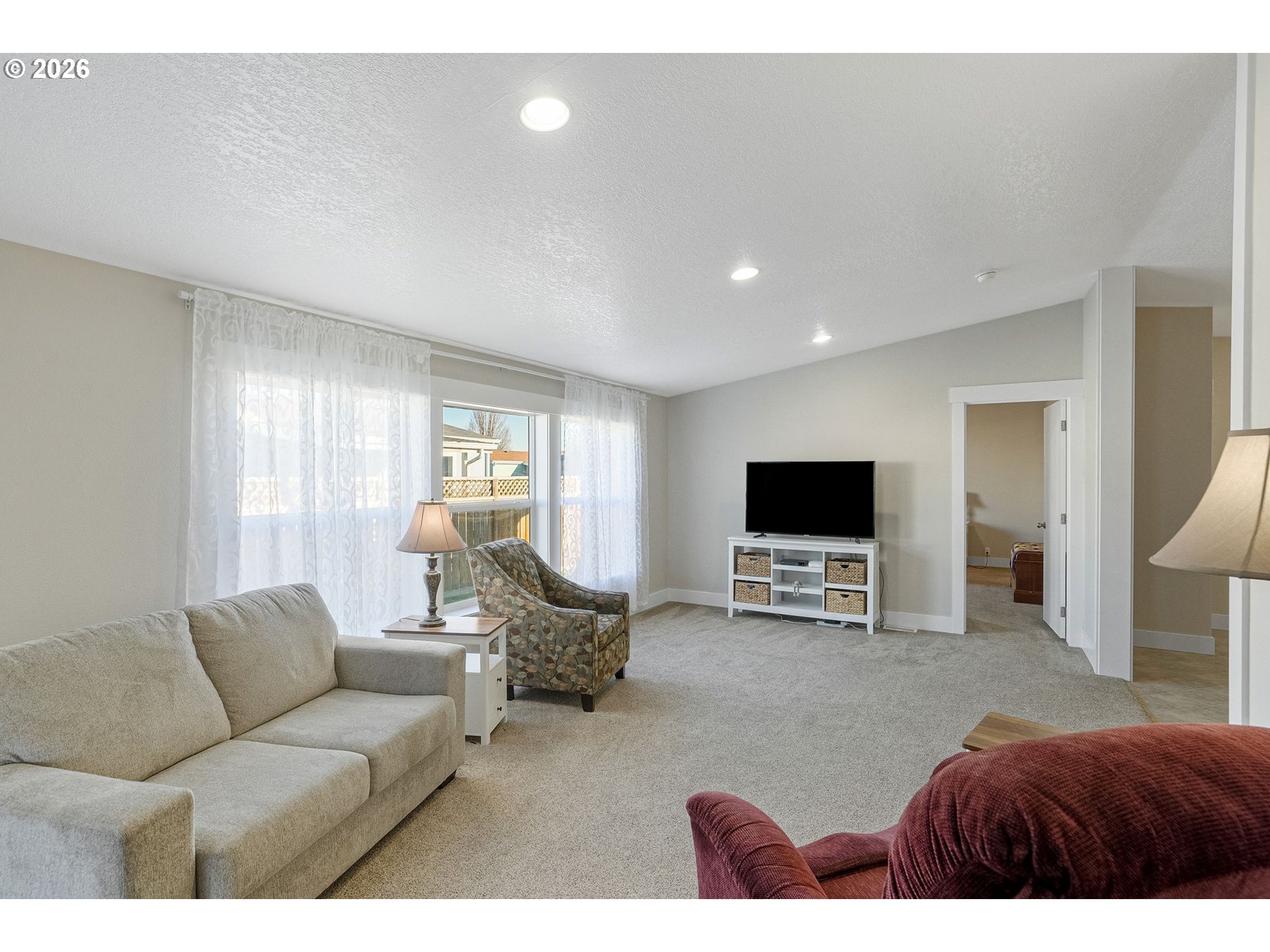 1015 Oak Street, Unit 74 Silverton, OR 97381 - Photo 8 of 33 a living room with furniture and a flat screen tv