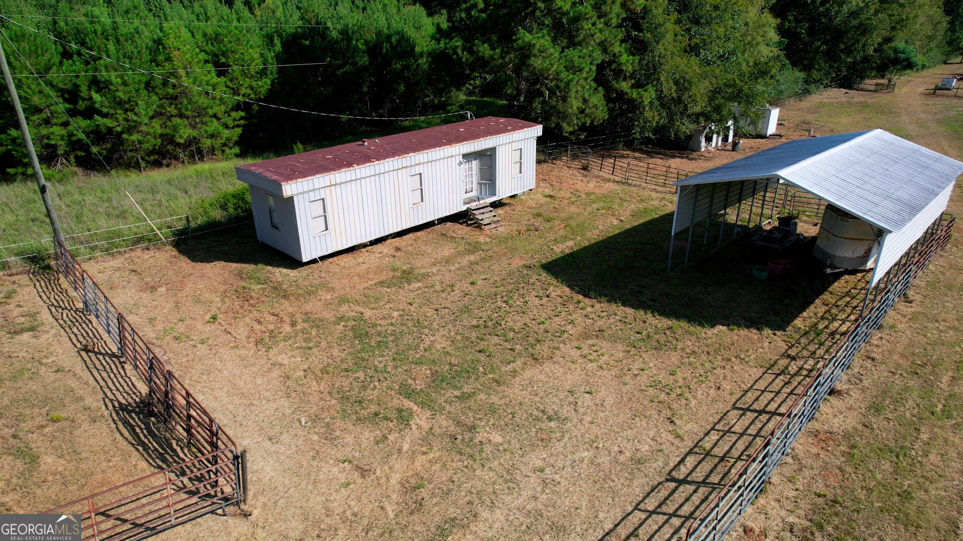 2911 A Sandy Creek Road Madison, GA 30650 - Photo 13 of 41 a view of a backyard with chairs and a stove