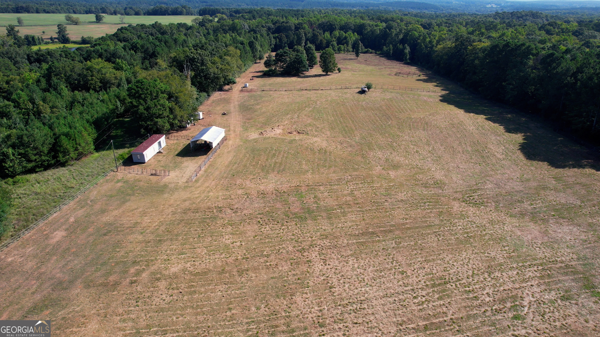 2911 A Sandy Creek Road Madison, GA 30650 - Photo 15 of 41 a view of a dry yard with wooden fence