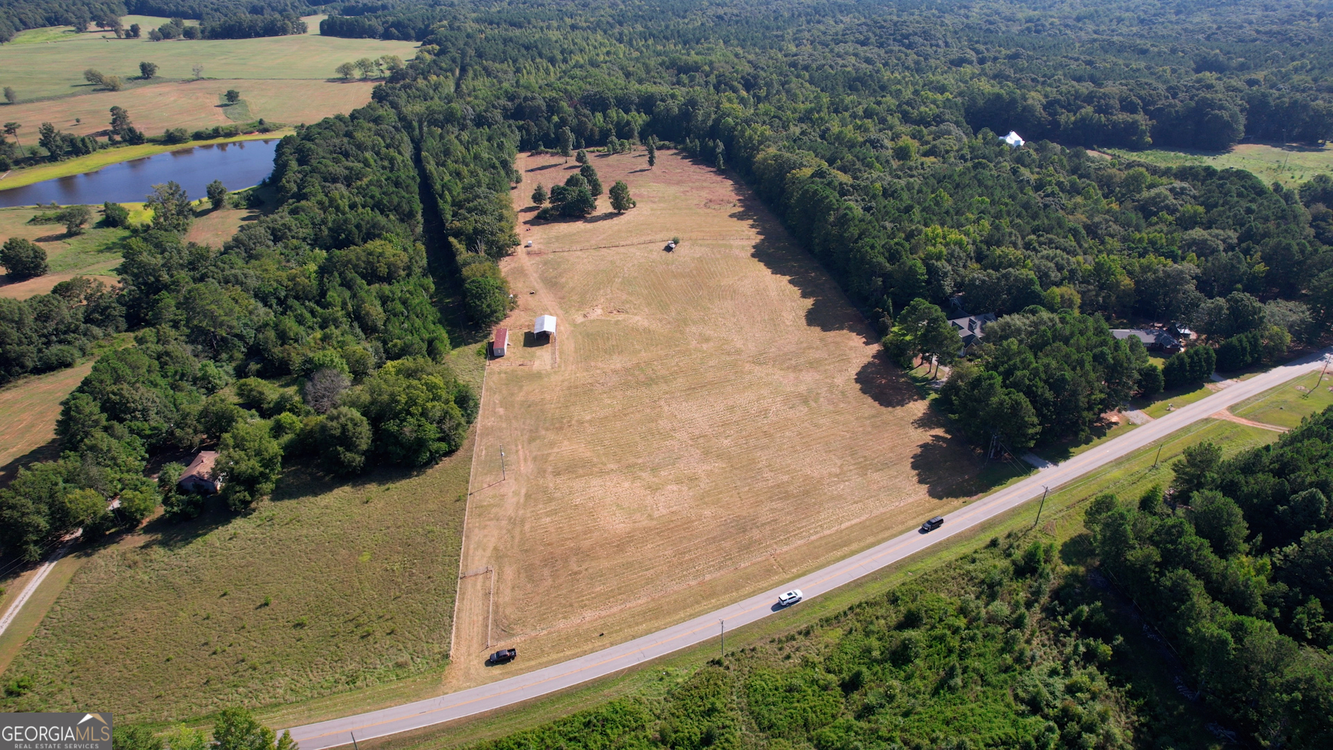 2911 A Sandy Creek Road Madison, GA 30650 - Photo 4 of 41 an aerial view of a house with a yard and trees