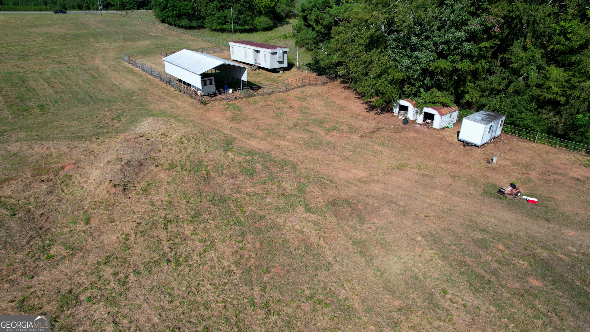 2911 A Sandy Creek Road Madison, GA 30650 - Photo 10 of 41 a view of a bench in middle of the field