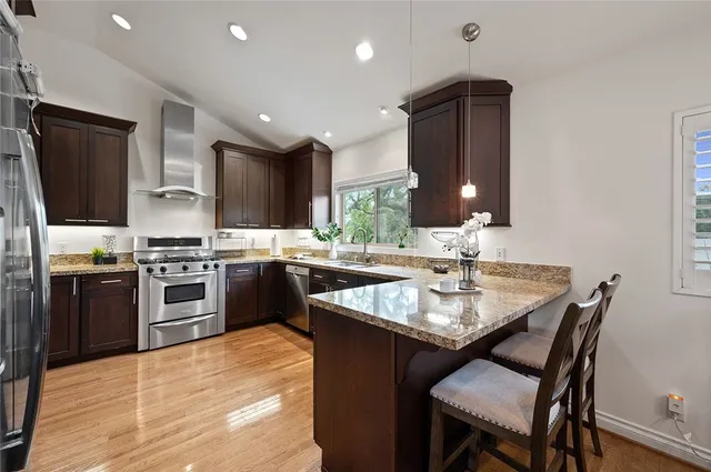 a kitchen with a stove a sink and a refrigerator