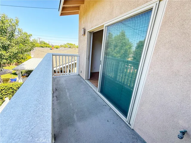 a view of balcony and floor to ceiling window
