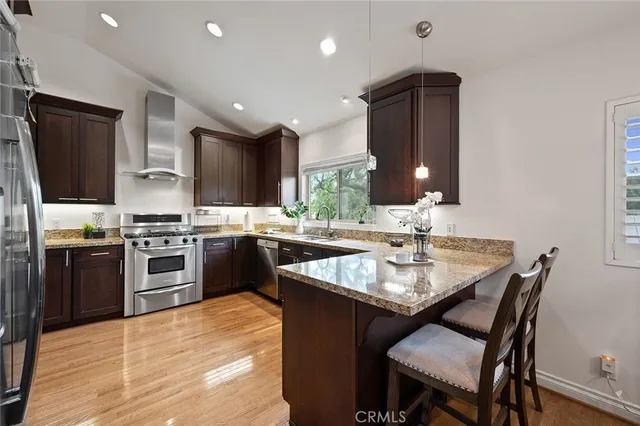 a kitchen with a stove a sink and a refrigerator