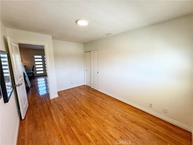 wooden floor in an empty room with a mirror