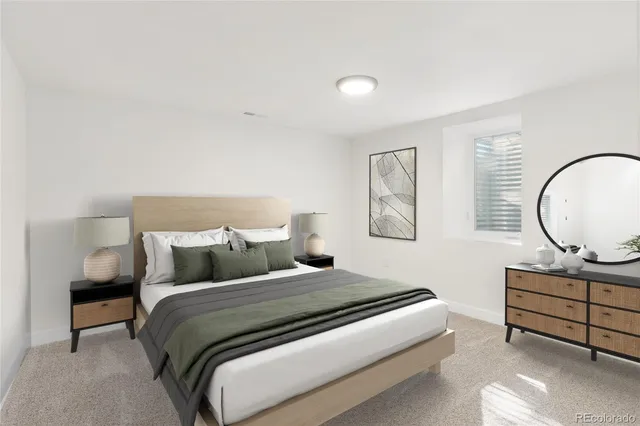 a bedroom with a bed a mirror and a window