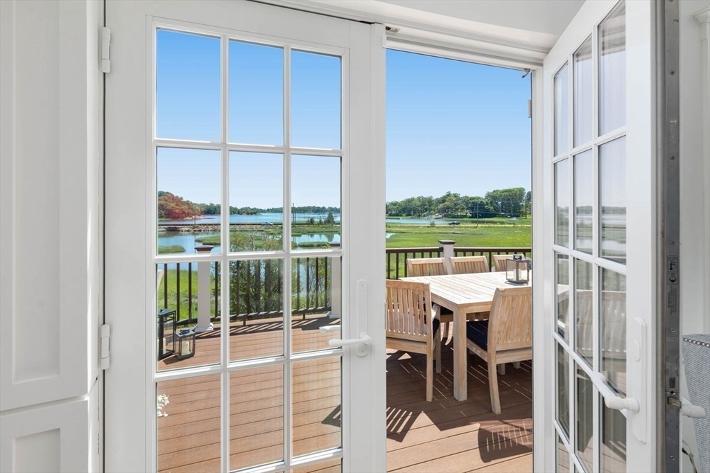 31 Bow Street Cohasset, MA 02025 - Photo 12 of 42 a view of a room with a large window and chair