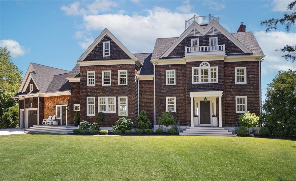 31 Bow Street Cohasset, MA 02025 - Photo 2 of 42 a front view of a house with a yard