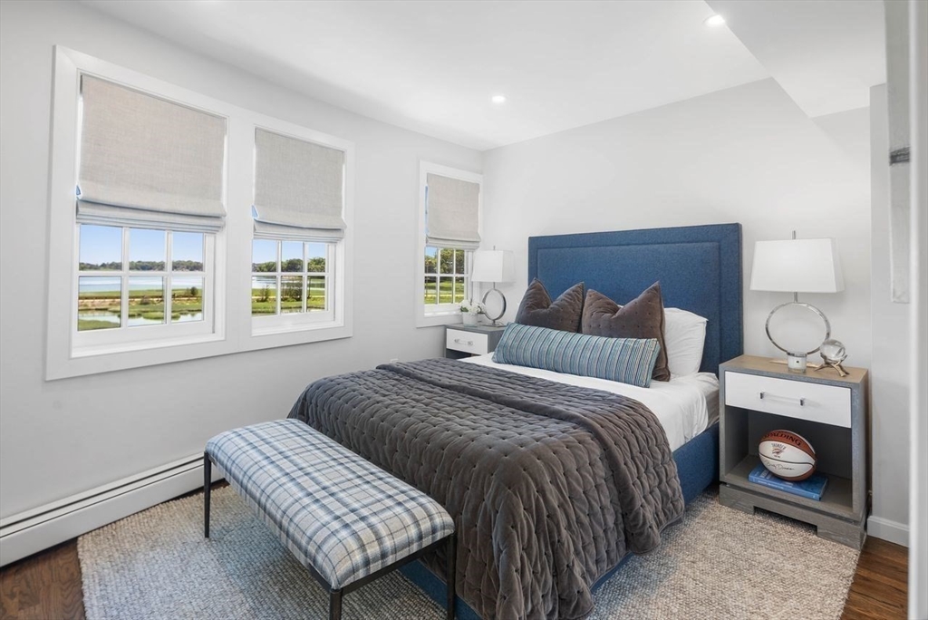 31 Bow Street Cohasset, MA 02025 - Photo 27 of 42 a bedroom with a bed and a fireplace