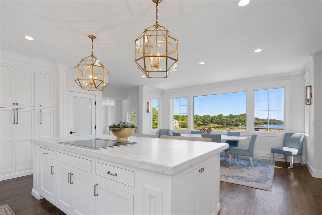 31 Bow Street Cohasset, MA 02025 - Photo 3 of 42 a kitchen with a sink dishwasher a dining table and chairs with wooden floor