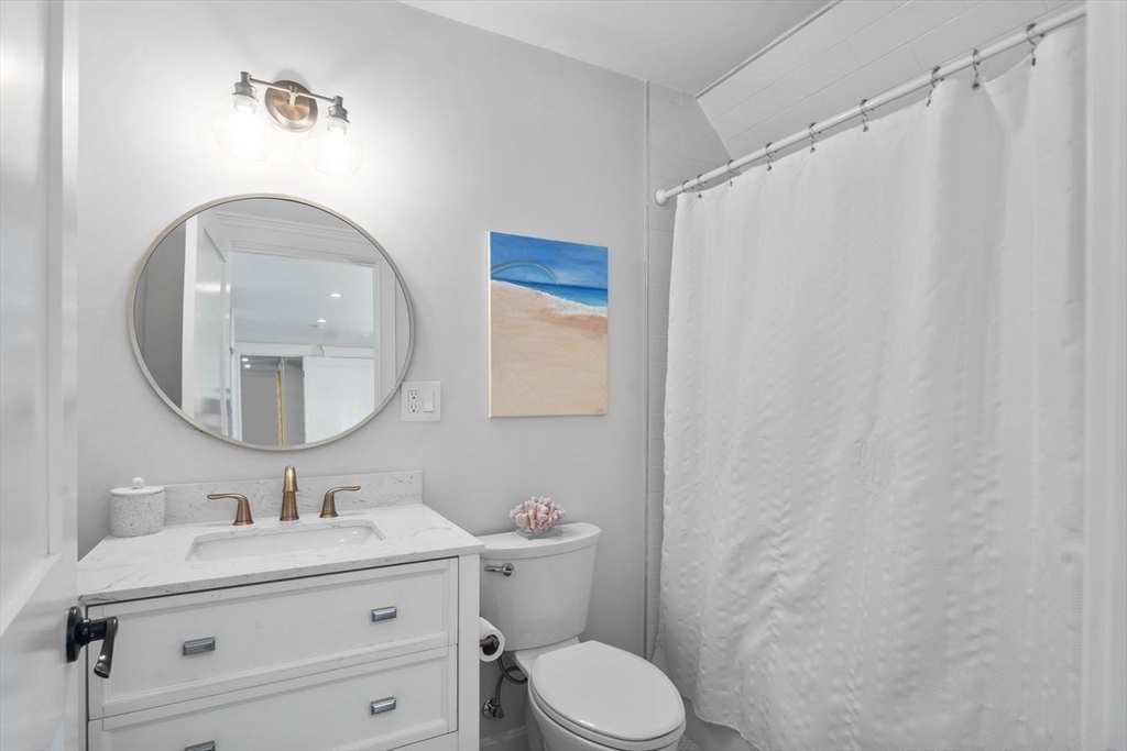 31 Bow Street Cohasset, MA 02025 - Photo 31 of 42 a bathroom with a granite countertop sink mirror vanity and toilet