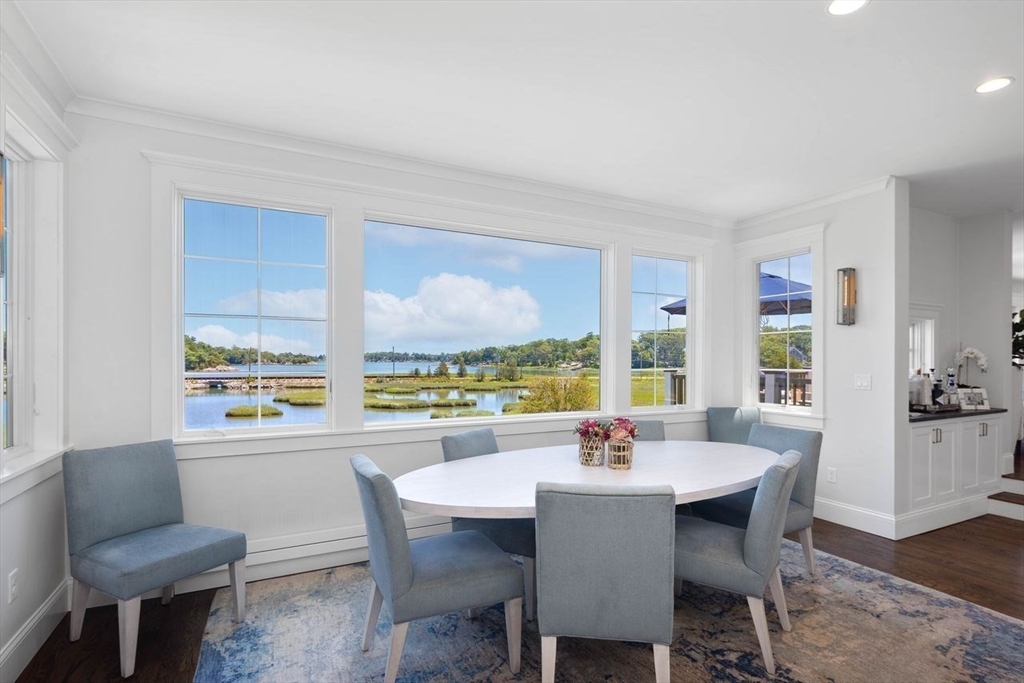 31 Bow Street Cohasset, MA 02025 - Photo 5 of 42 a dining room with furniture a rug and a floor to ceiling window