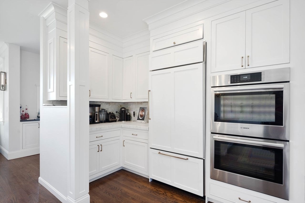 31 Bow Street Cohasset, MA 02025 - Photo 6 of 42 a kitchen with white cabinets stainless steel appliances and wooden floor