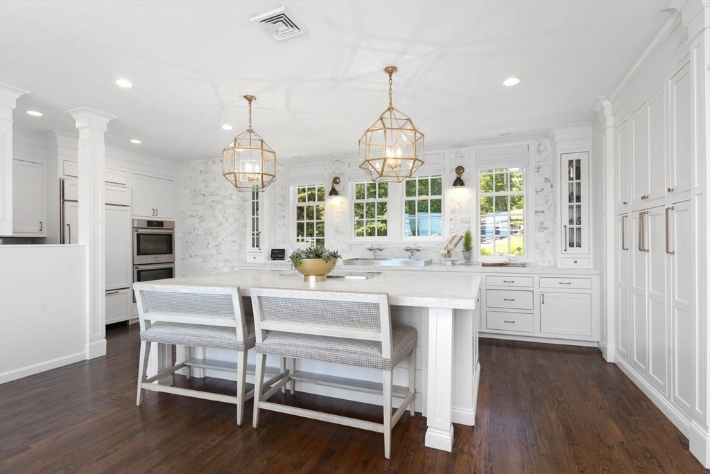 31 Bow Street Cohasset, MA 02025 - Photo 9 of 42 a kitchen with kitchen island stainless steel appliances and wooden floor
