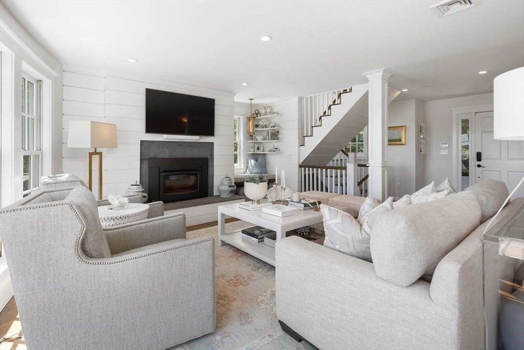 31 Bow Street Cohasset, MA 02025 - Photo 10 of 42 a living room with furniture a fireplace and a flat screen tv