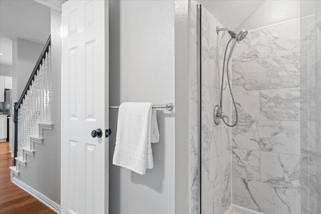 10801 Beachmont Lane Austin, TX 78739 - Photo 23 of 40 Convenient walk-in shower in your downstairs guest bathroom, recently remodeled with crisp white and grey finishes
