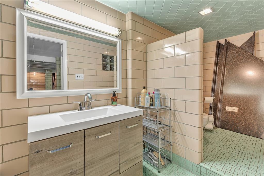 250 Neville Road Beaver, PA 15009 - Photo 20 of 25 Lower level full bath has shower, newer vanity and private toilet.