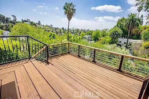 a view of balcony with wooden floor and fence