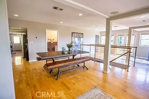 a living room with furniture pool table and windows