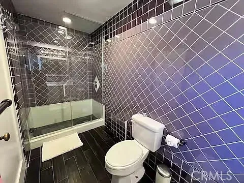 a bathroom with a toilet and a shower