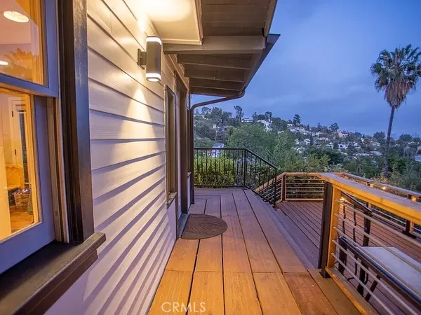 a view of balcony with wooden floor and fence