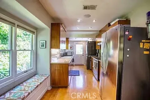 a kitchen with stainless steel appliances granite countertop a refrigerator and a stove
