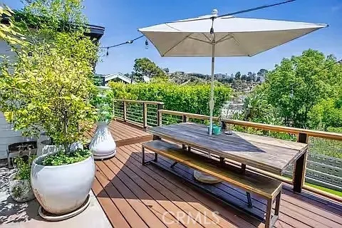 a view of a roof deck with potted plants