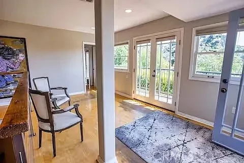 a view of a bedroom with furniture and a window