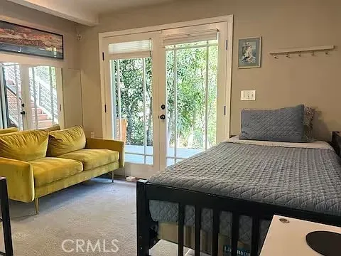 a bedroom with a bed and a couch