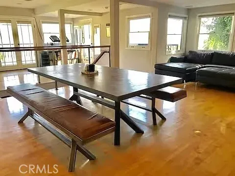 a living room with table chairs and a dining table