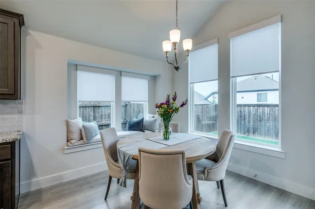 a view of a dining room with furniture wooden floor and chandelier