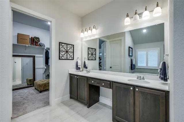 a bathroom with a sink double vanity and a mirror