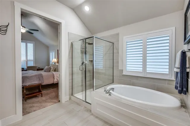 a spacious bathroom with a bathtub and a shower