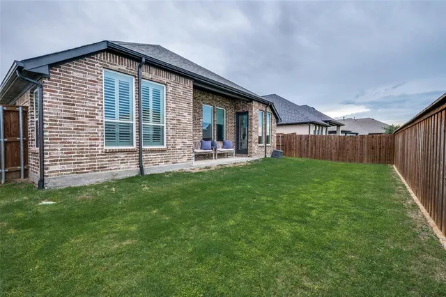 a front view of house with yard and outdoor seating