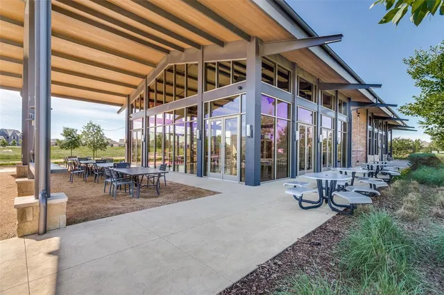a backyard of a house with outdoor seating and lake view