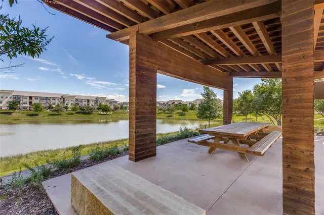 an aerial view of a house with a garden and lake view