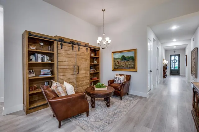 a living room with furniture a rug and a chandelier