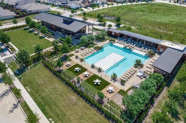 an aerial view of residential houses with yard