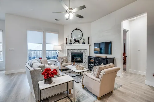 a living room with furniture a fireplace and a flat screen tv