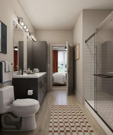 a bathroom with a sink a toilet and shower