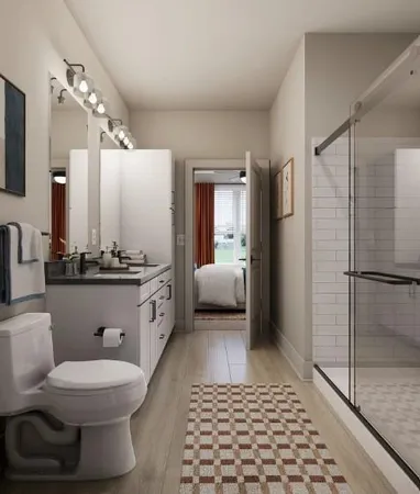 a bathroom with a double vanity sink a toilet a mirror and shower